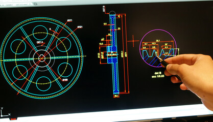 enginer designing on computer a mechanical piece detail