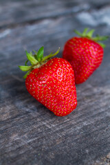 two strawberries on wood