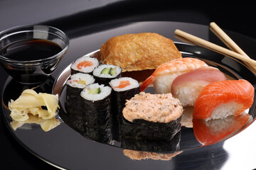 close up of sashimi sushi set with chopsticks and soy - sushi roll with salmon and sushi roll, delicious maki and nigiri
