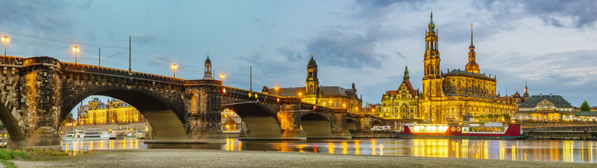 Fototapeta premium view of the historic part of Dresden, city lights reflecting on the River Elbe.