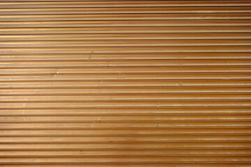 Close up of aluminium metal roller shutter door, Brown color. background