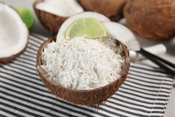 Tasty rice in coconut shell on table