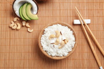 Tasty coconut rice with cashew nuts on bamboo mat