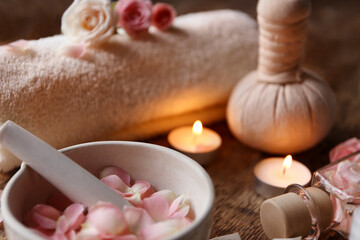 Fototapeta na wymiar Beautiful spa composition with rose petals in bowl on wooden table