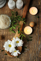 Fototapeta na wymiar Beautiful spa composition with flowers and candles on wooden table