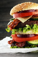 fresh tasty burger on wooden grey background