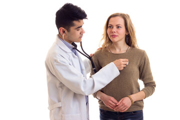 Doctor listening heartbeat of the woman 