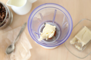 Blender cup with butter on table