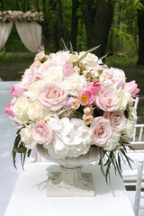 Beautiful wedding bouquet in stone vase, outdoors