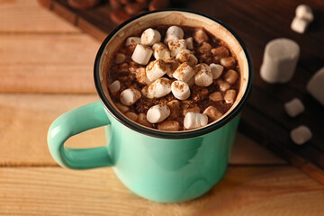 Cup of cocoa with marshmallows on wooden table