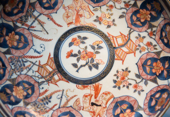 Fototapeta na wymiar Floral decorative pattern on an antique porcelain plate