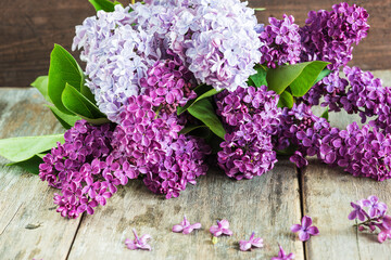 bouquet of lilac flowers on rustic wooden background