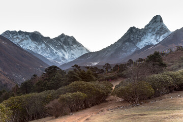 Sunrise in Himalayas. Ama Dablam, Nuptse, Lhotse and Everest in first rays of sun. Two...