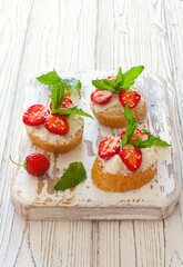 Toasts with oat  bread, ricotta and fresh strawberries