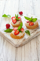 Toasts with oat  bread, ricotta and fresh strawberries