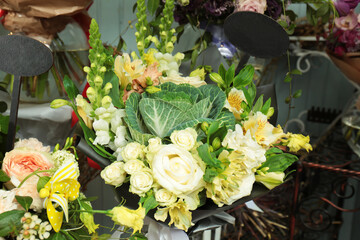 Beautiful creative bouquet with decorative cabbage in flower shop
