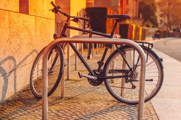 locked bicycle in sunset backlit at street