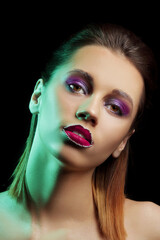 Fototapeta premium Beautiful young woman with creative makeup on dark background