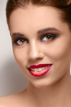 Beautiful young woman with creative makeup on light background, closeup