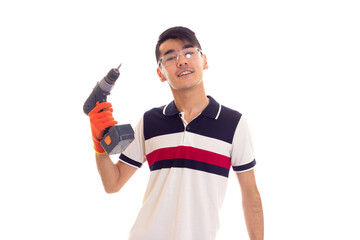 Young man with gloves and glasses holding electric screwdriver