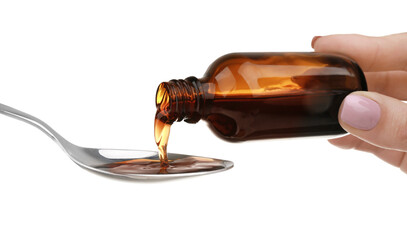 Pouring cough syrup into spoon on white background