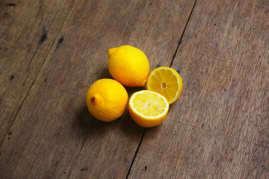 Yellow Fresh Lemon Slice Over Wooden Background