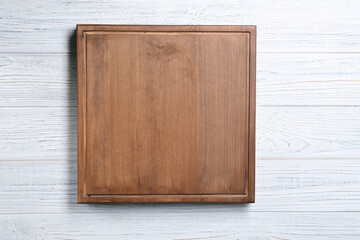 Square wooden board on table