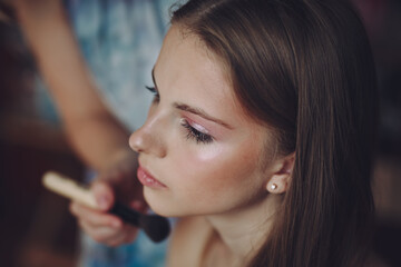 Young model getting her makeup done