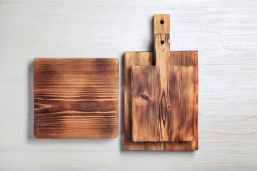 Fototapeta premium Set of cutting boards on white wooden background