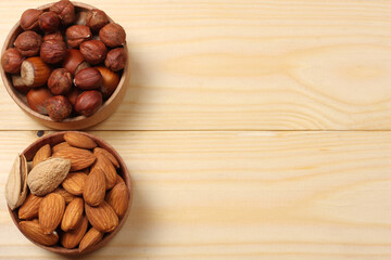 mix almonds and hazelnut in wood bowl on wood background. Top view with copy space