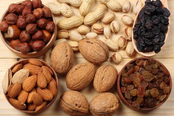 mix almonds, cashew nuts, hazelnut, peanuts, walnuts, pistachio on wood background top view