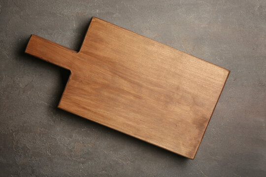 Wooden cutting board on gray background