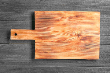 Cutting board on wooden background