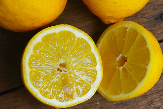 Yellow Fresh Lemon Slice Over Wooden Background