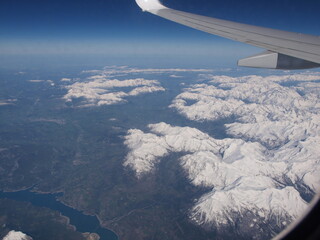 Fototapeta na wymiar Flug über die verschneiten Alpen