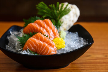 Fresh salmon sashimi on wooden table