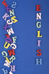 English word on blue background composed from colorful abc alphabet block wooden letters, copy space for ad text. Learning english concept.