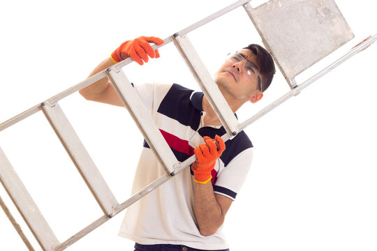 Young man in gloves and glasses holding a ledder 