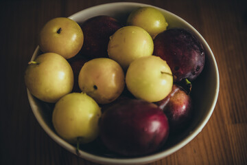 Fresh plums in bowl.