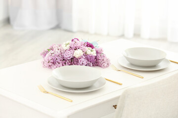 Beautiful lilac flowers on table