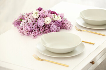 Beautiful lilac flowers on table