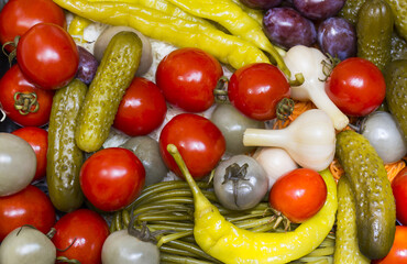 Background of pickled cucumbers, tomatoes, garlic, pepper, onions, cabbage close-up