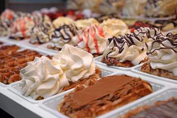 Delicious dessert with whipped cream on showcase