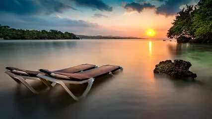 Afwasbaar fotobehang Sunset with beach chairs on a tropical beach in Jamaica. © mandritoiu