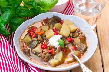Lentil soup with summer vegetables and sour cream