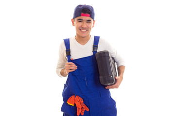 Young man in overall holding toolbox