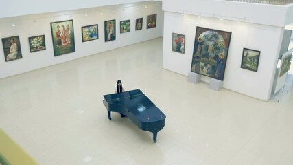 Pianist playing the piano in art gallery - Powered by Adobe