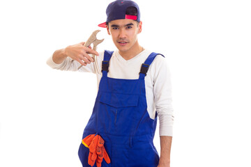 Young man in overall holding spanner