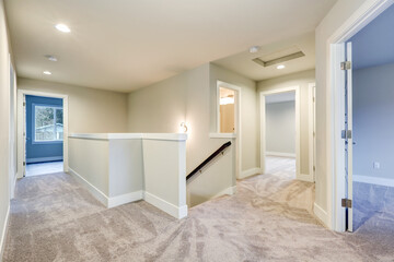 Fototapeta na wymiar Second floor landing with creamy walls and beige carpet floor