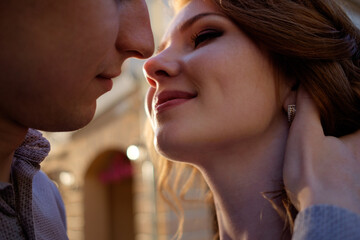 portrait of happy couple before kiss in sunset light. Love concept